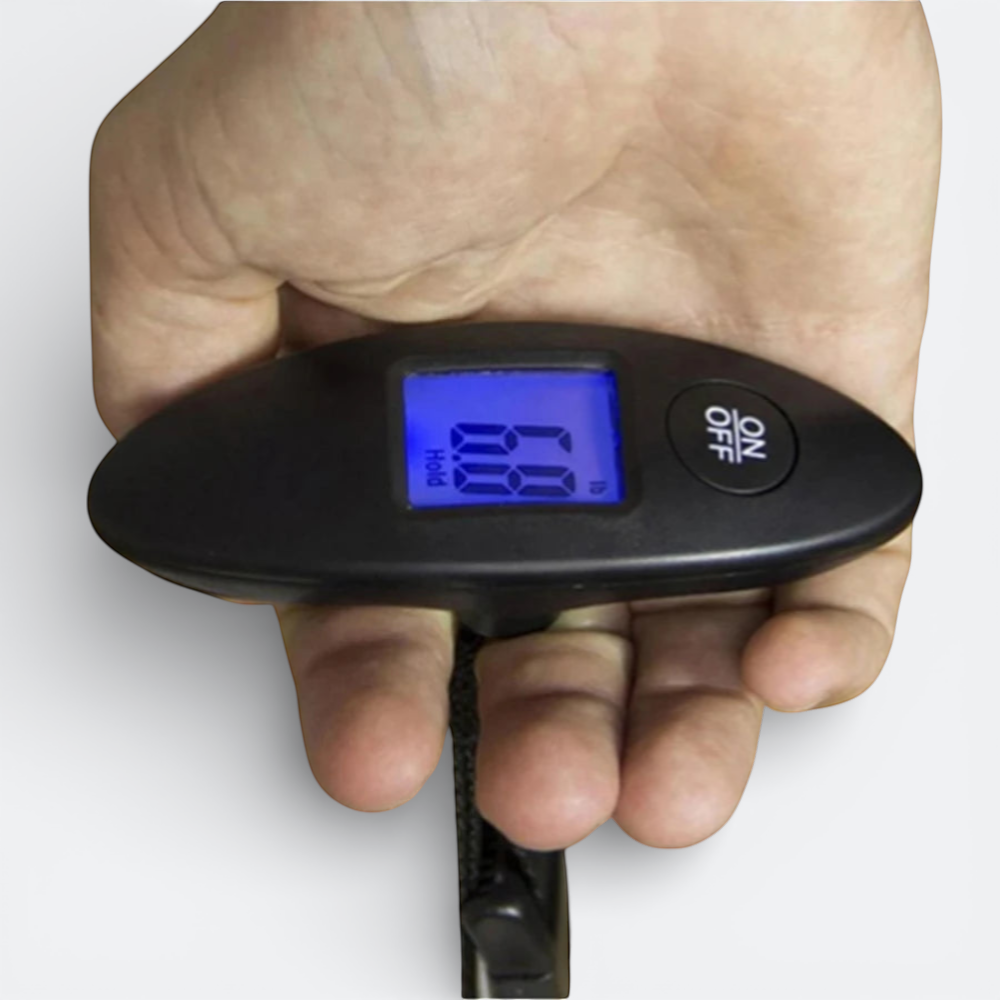 AïtaVia black portable digital luggage scale with blue LCD screen showing weight, held in a hand.