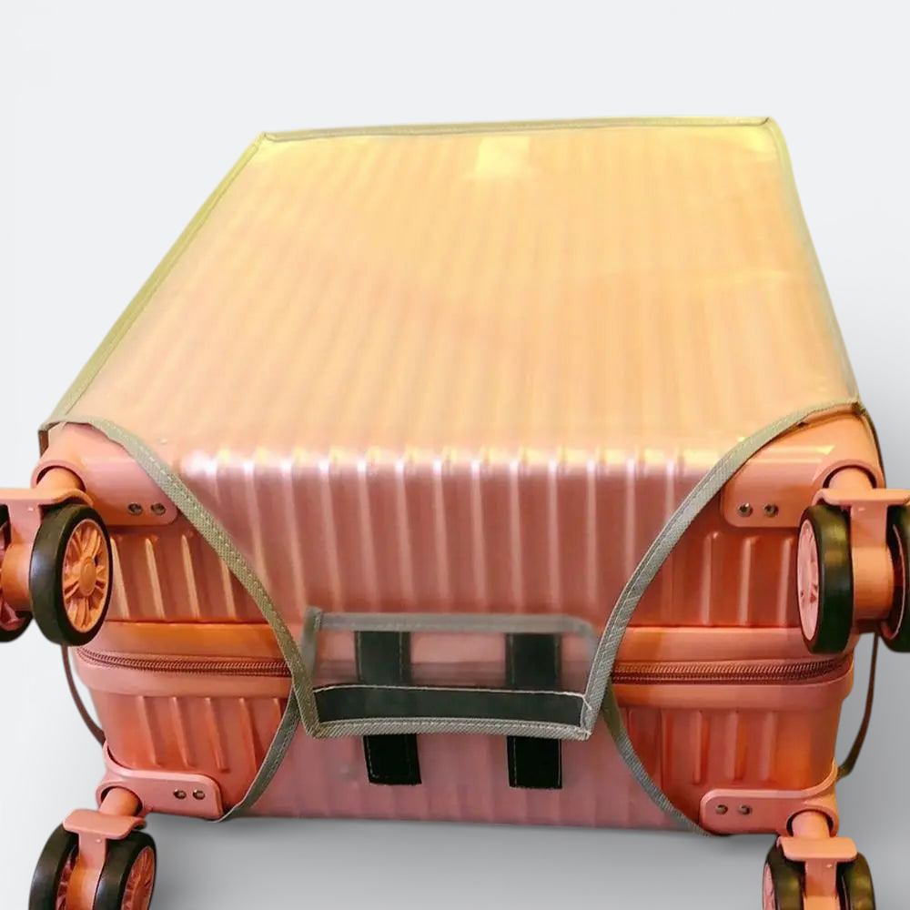 AïtaVia clear PVC suitcase cover protecting a pink ribbed suitcase. Features elasticated edges and cutouts for wheels and handles.