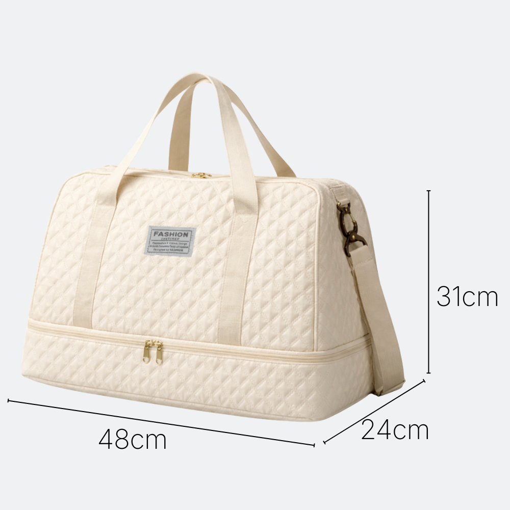AïtaVia cream quilted travel duffel bag with adjustable shoulder strap and top handles. Features a separate zippered compartment at the bottom.
