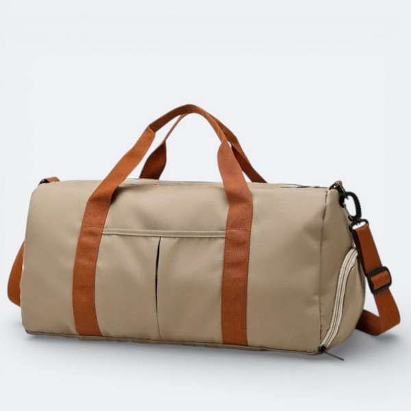 AïtaVia beige duffel bag with tan straps and a detachable shoulder strap, featuring front pockets and a zippered side compartment.