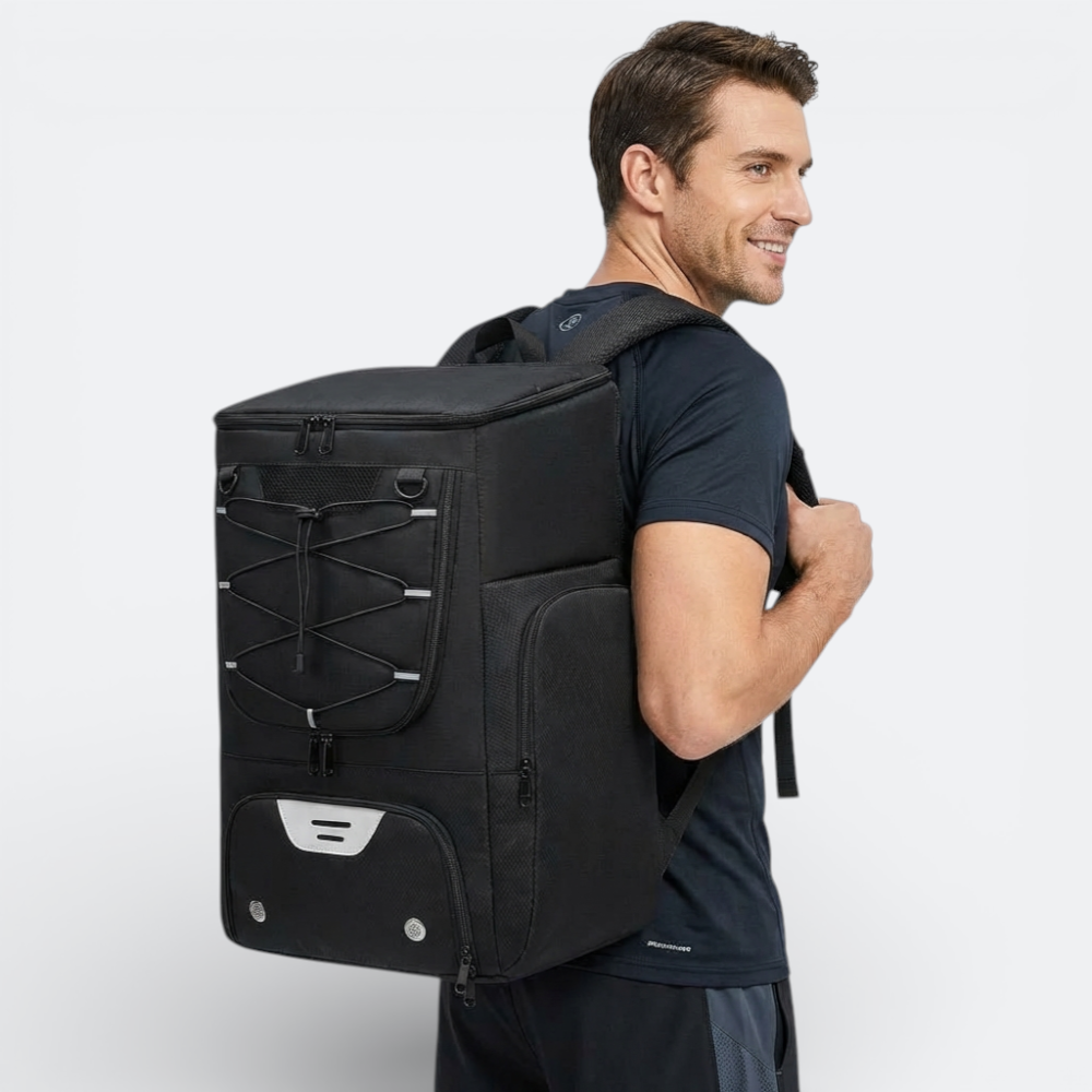 AïtaVia black basketball backpack with bungee cord front and multiple zippered compartments, worn by a man.