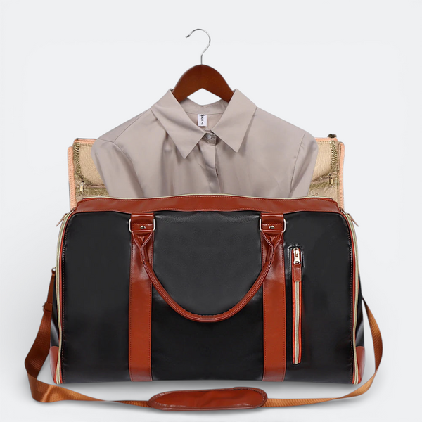 AïtaVia black and brown faux leather duffel bag with a beige collared shirt hanging inside.