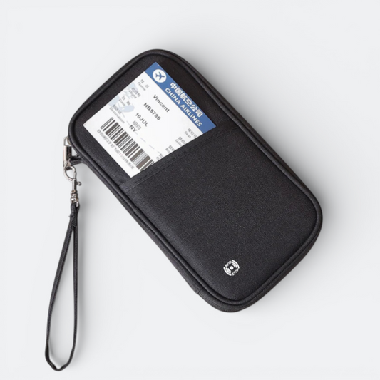 AïtaVia black fabric family passport holder with a front pocket holding a boarding pass and a wrist strap.
