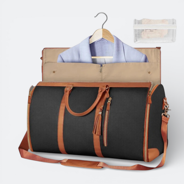 AïtaVia black foldable duffel bag with tan leather accents and a light blue jacket on a hanger inside.