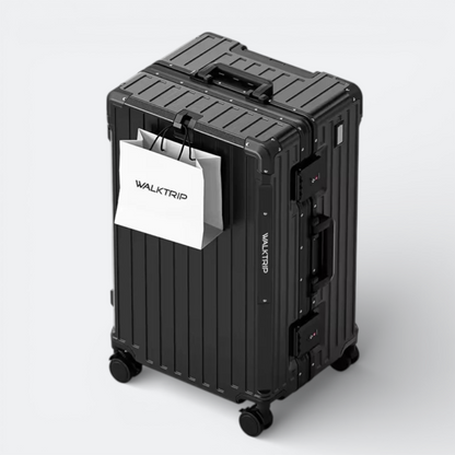 AïtaVia black large hard-shell suitcase with spinner wheels and TSA lock, featuring a white shopping bag.