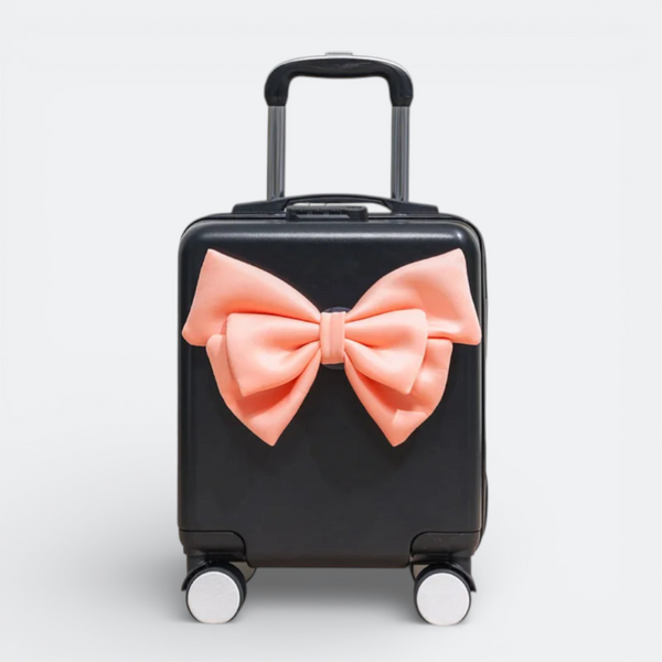 AïtaVia black mini suitcase with a large peach bow accent and silver telescopic handle.