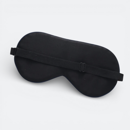 AïtaVia black silk sleep mask with adjustable elastic strap for travel and comfortable sleep.