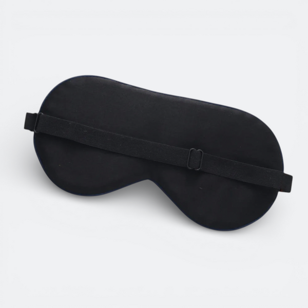 AïtaVia black silk sleep mask with adjustable elastic strap for travel and comfortable sleep.