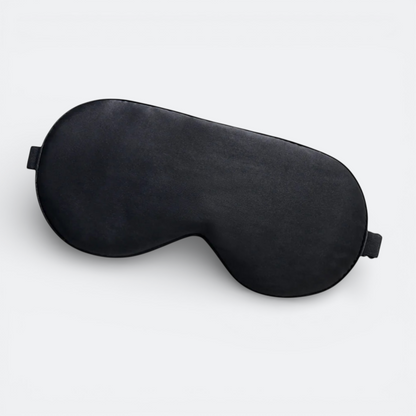AïtaVia black silk sleep mask with adjustable strap for travel and comfortable sleep.