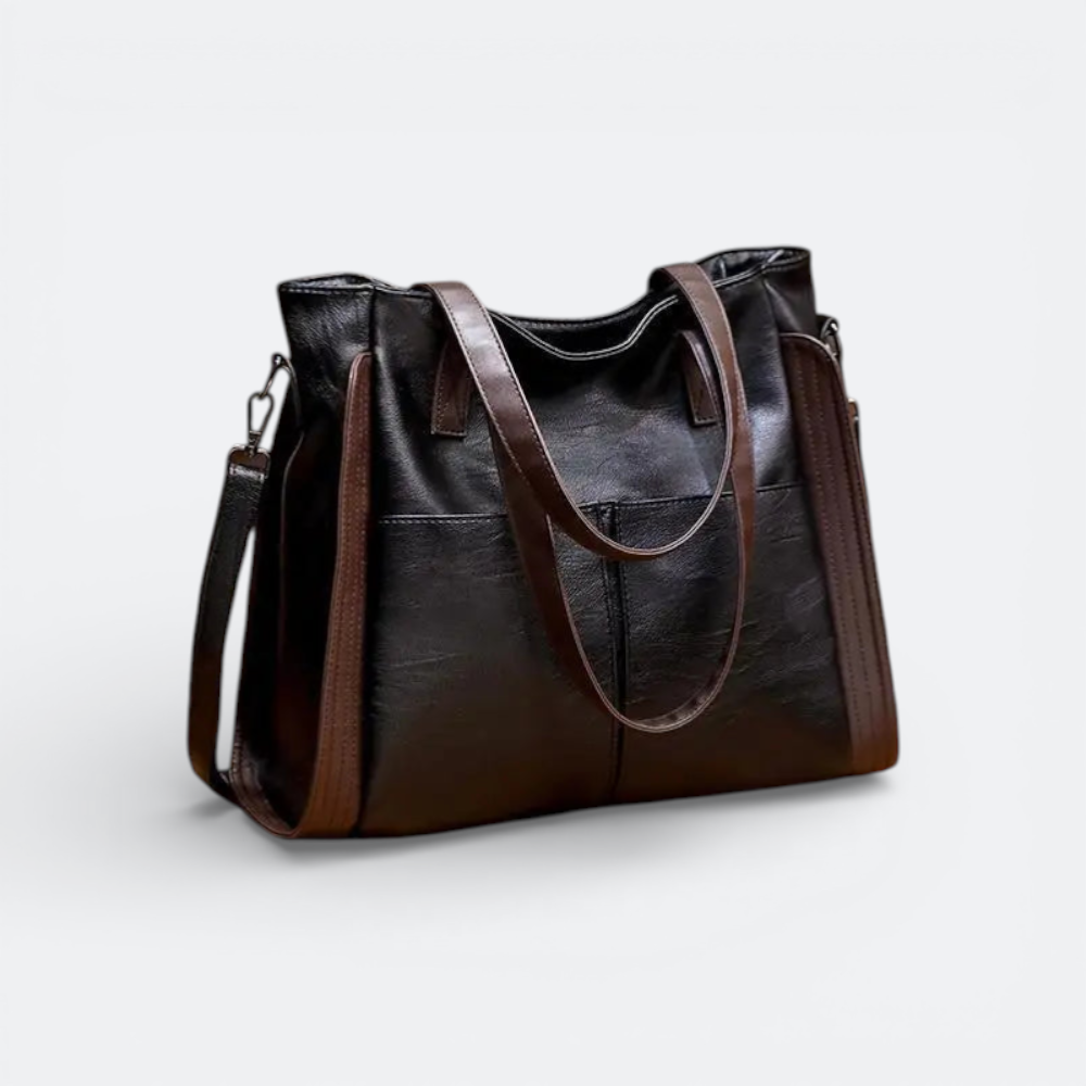 AïtaVia black soft leather tote bag with brown strap accents and multiple exterior pockets.