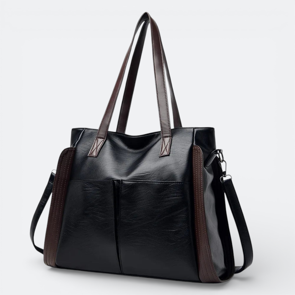 AïtaVia black soft leather tote bag with brown accents and two front pockets, featuring shoulder straps and a detachable crossbody strap.