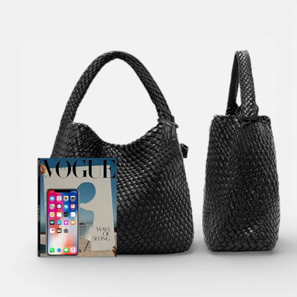 AïtaVia black woven leather large hobo handbag with braided strap. A smartphone and Vogue magazine are placed next to it for scale.
