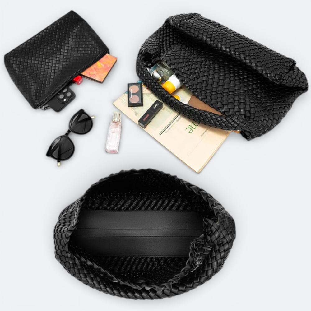 AïtaVia black woven leather large tote bag with sunglasses, makeup, and perfume.