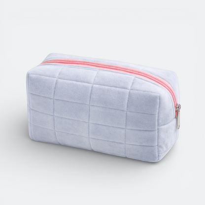 AïtaVia light blue plush quilted makeup bag with pink zipper, ideal for travel and daily organization.