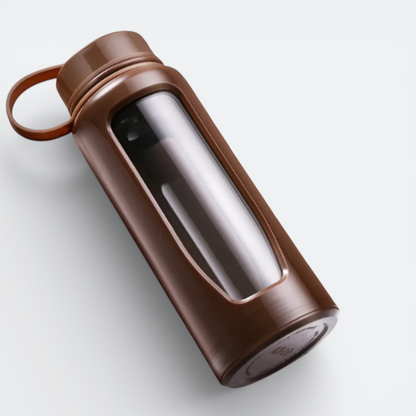 AïtaVia brown glass water bottle with a clear window and a loop on the cap.