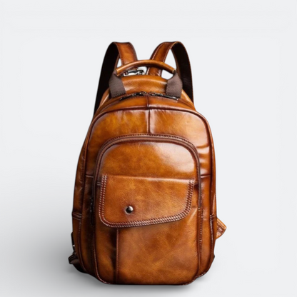 AïtaVia brown genuine leather backpack for men with multiple pockets and a snap closure on the front pocket.