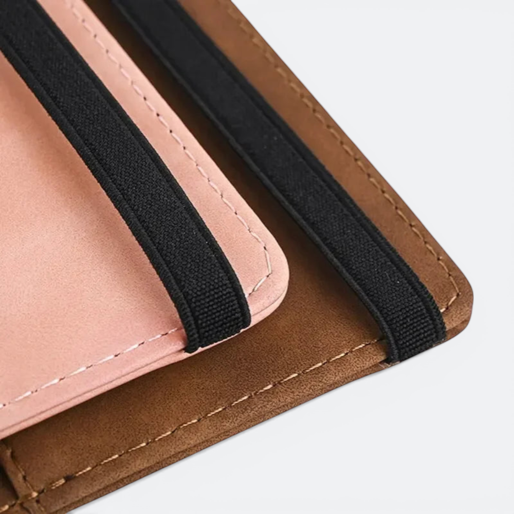 AïtaVia brown faux leather passport holder with pink interior and black elastic straps.
