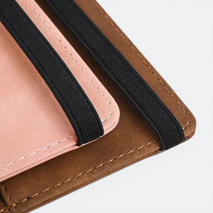 AïtaVia brown faux leather passport holder with pink interior and black elastic straps.