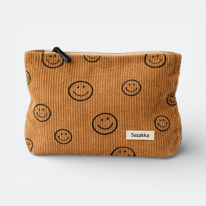 AïtaVia brown corduroy travel pouch with all-over smiley face print and black zipper.