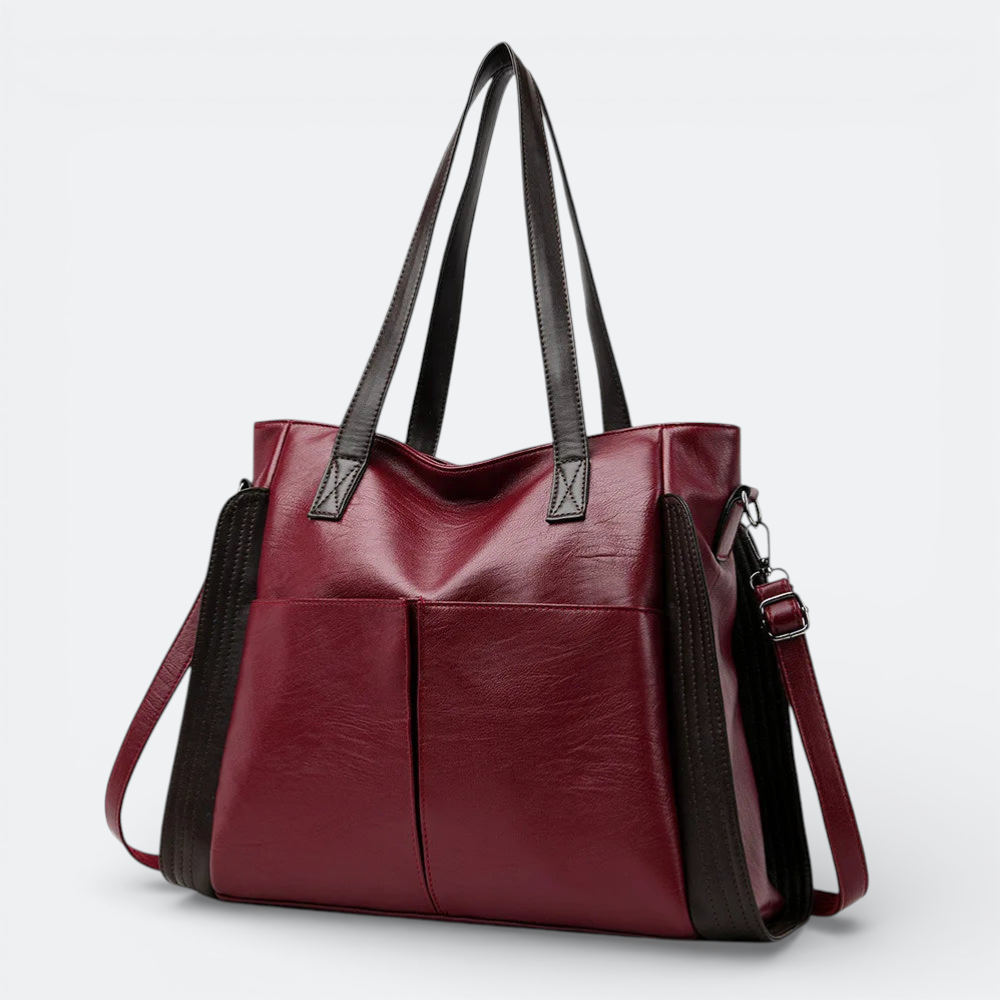 AïtaVia burgundy soft leather tote bag with dark brown accents and two front pockets.