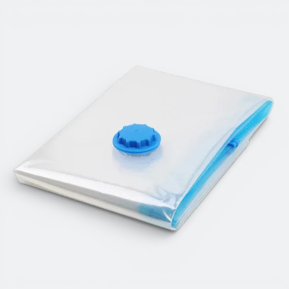 AïtaVia clear compression bag with blue valve and zipper for travel clothing organization.