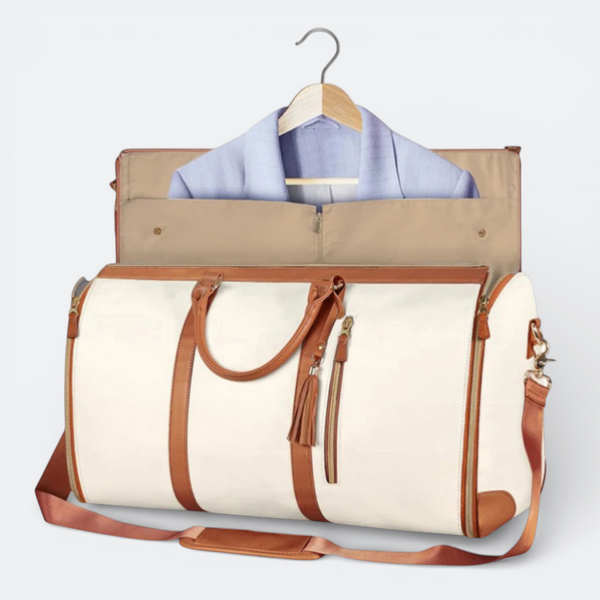 AïtaVia cream canvas duffel bag with brown leather trim and garment compartment. Features top handles, shoulder strap, and tassel zipper pull.