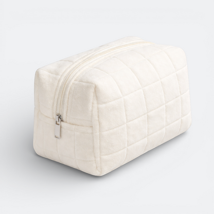 AïtaVia cream plush quilted makeup bag with a silver zipper. Soft, compact, and ideal for travel.