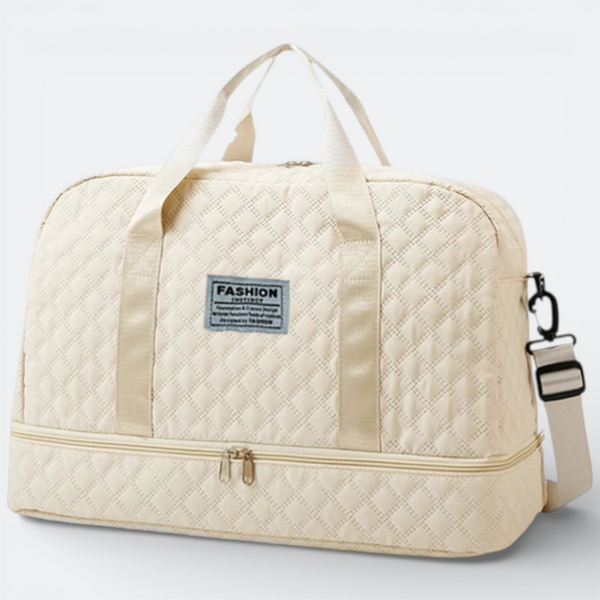 AïtaVia cream quilted travel duffel bag with adjustable shoulder strap and zippered bottom compartment.