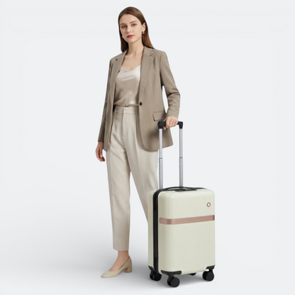 AïtaVia cream suitcase with removable wheels and rose gold accent, held by a woman in a beige suit.
