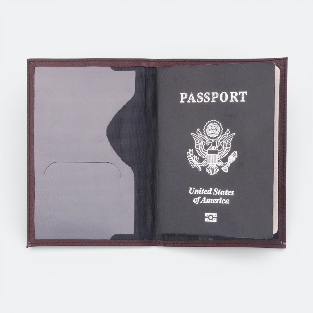 AïtaVia dark brown textured leather passport holder with a US passport inside.