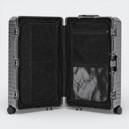AïtaVia dark grey aluminium frame suitcase, open to show black interior with mesh pockets and straps.