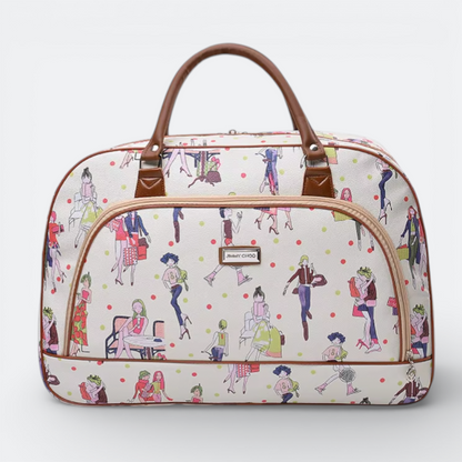AïtaVia white travel duffel bag with a playful print of fashion illustrations and polka dots, featuring brown leather handles and trim.