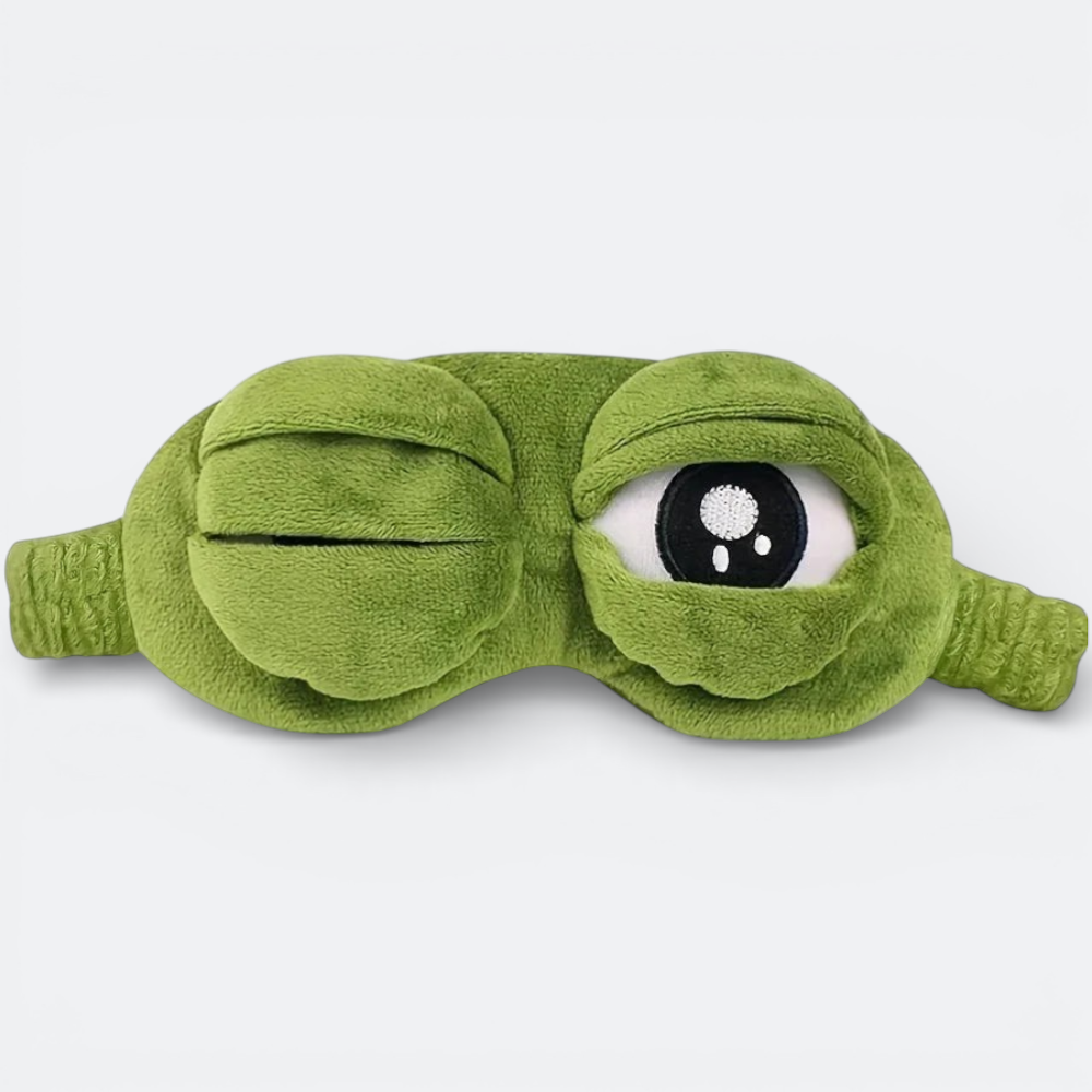 AïtaVia green plush frog-shaped sleep mask with large, expressive eyes, perfect for travel.