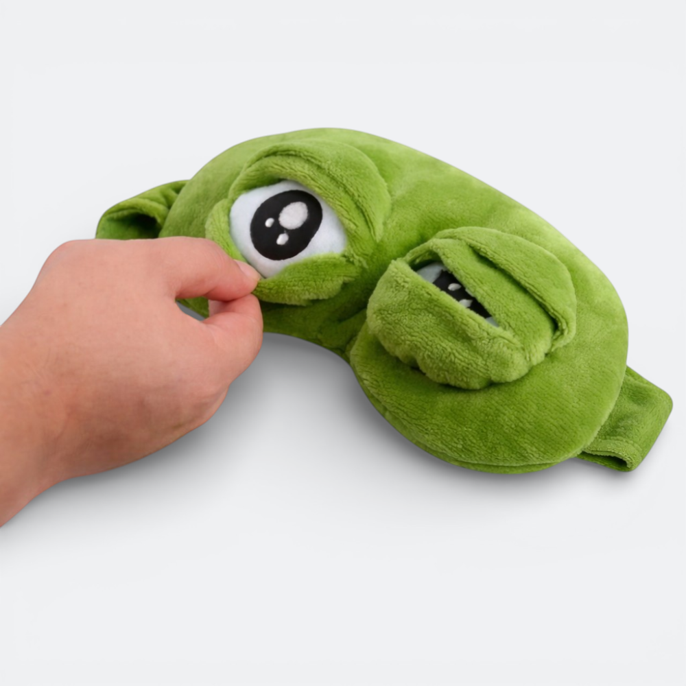 AïtaVia green plush frog eye sleep mask with large cartoon eyes and textured fabric.