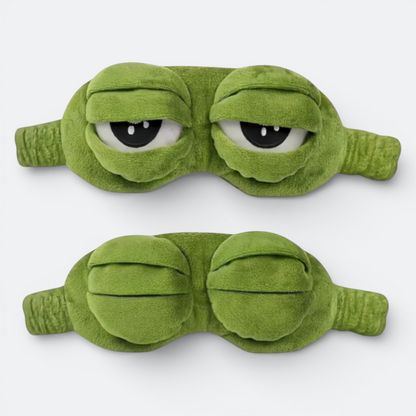 AïtaVia green plush frog-shaped sleep mask with large, sleepy eyes and a funny expression. Ideal for travel.