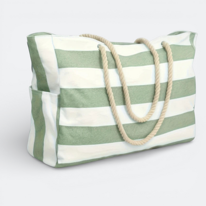 AïtaVia green and white striped canvas beach tote bag with rope handles and side pockets.