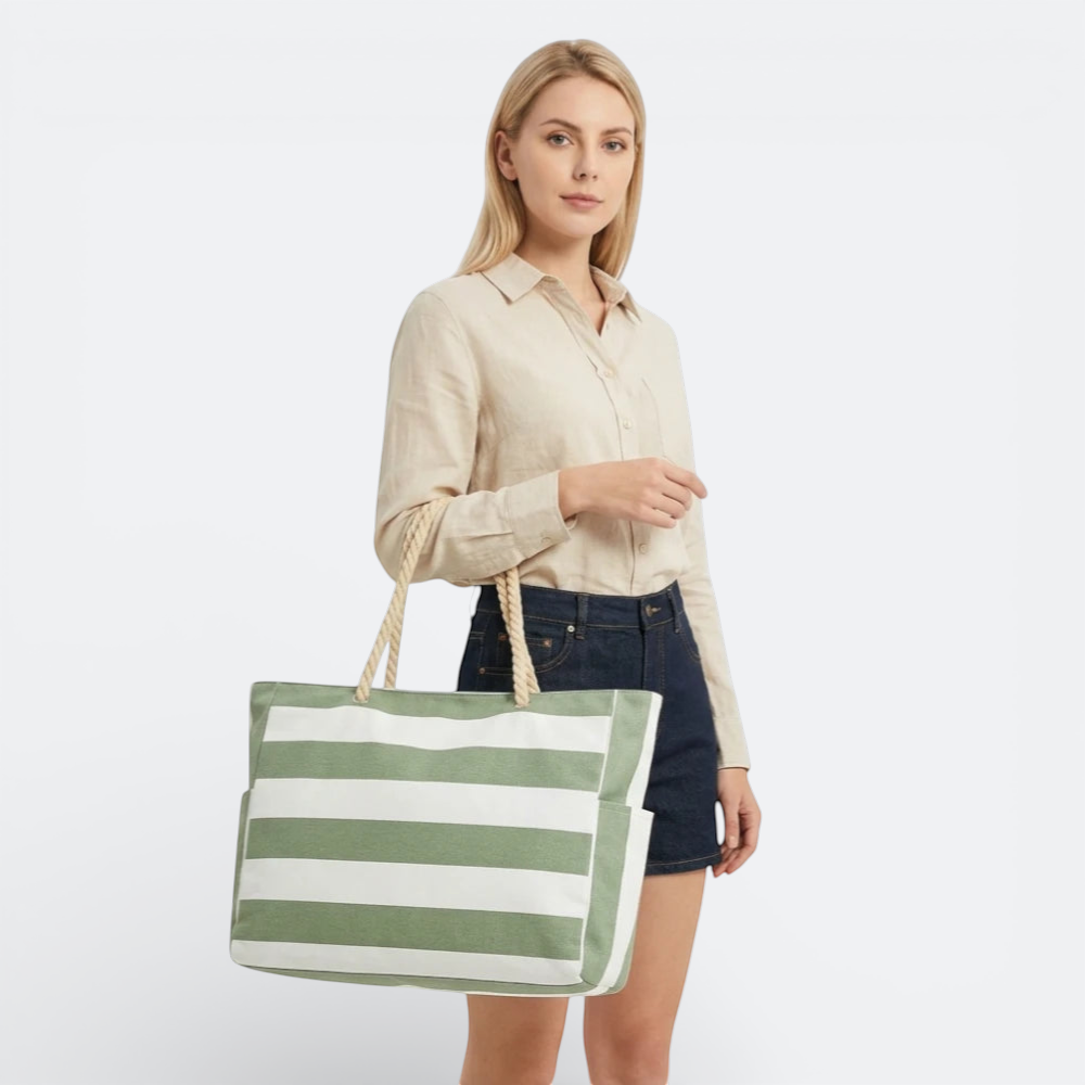 AïtaVia green and white striped canvas beach tote bag with rope handles and side pockets.
