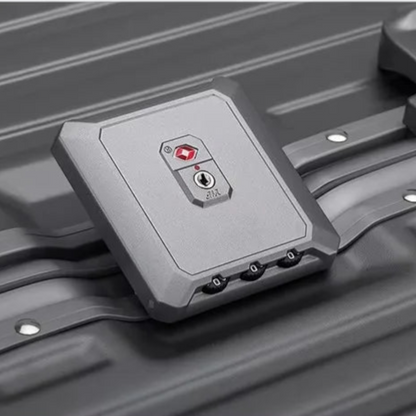 AïtaVia grey hard-shell suitcase with TSA lock and combination wheels. Durable and spacious for travel.