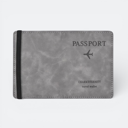 AïtaVia grey faux leather passport holder with an elastic band and embossed airplane and text.