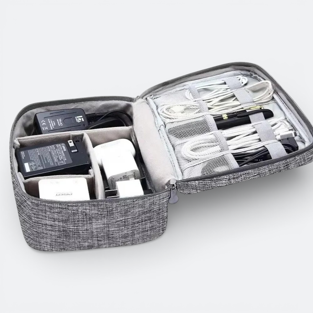 AïtaVia grey fabric travel organizer case with multiple compartments holding chargers, cables, and a pen.