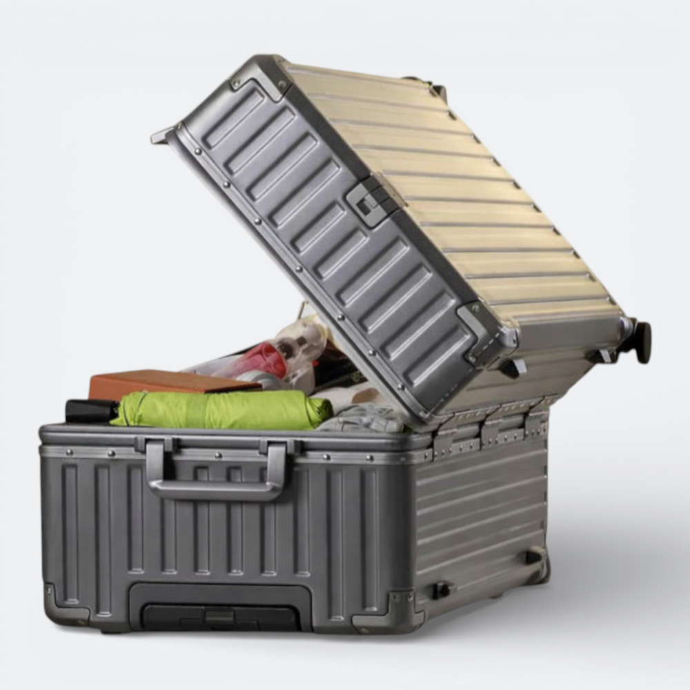 AïtaVia large silver hard-shell suitcase with spinner wheels, open and packed with travel essentials.