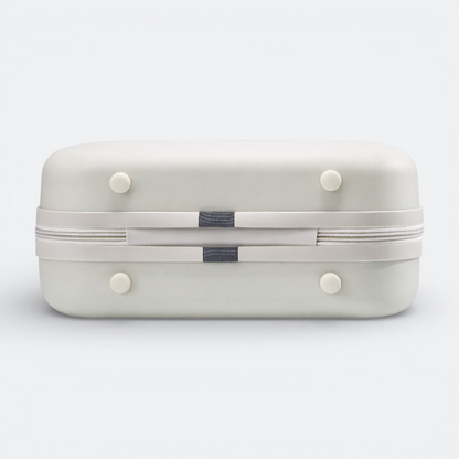 AïtaVia light grey hard-shell cosmetic case with a white zipper and grey fabric accents. Features four white feet.