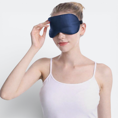 AïtaVia navy blue silk sleep mask with adjustable strap, designed for travel comfort and total darkness.