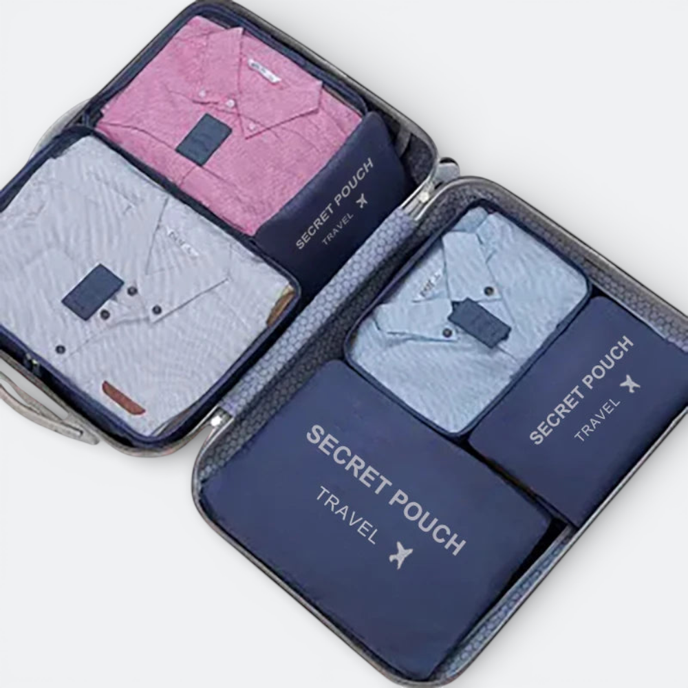 AïtaVia blue travel organizer set with pink and blue shirts neatly packed inside a suitcase.