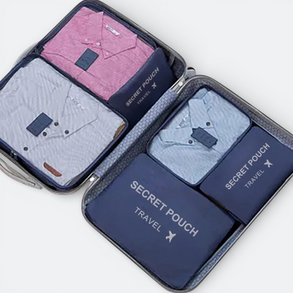 AïtaVia blue travel organizer set with pink and blue shirts neatly packed inside a suitcase.