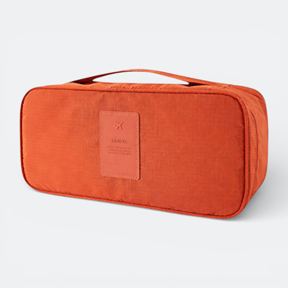 AïtaVia orange travel underwear organizer bag with a leather patch featuring a plane logo and text.