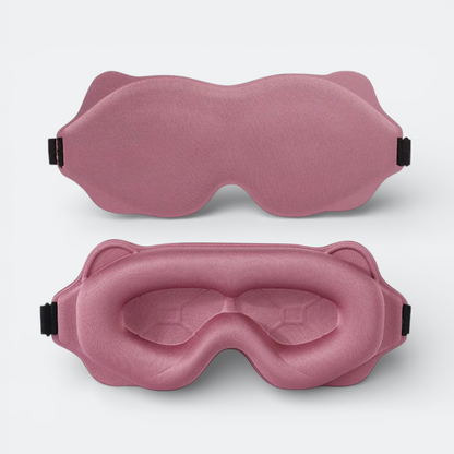 AïtaVia padded sleep mask in dusty rose, designed for travel comfort with contoured eye cups and adjustable strap.