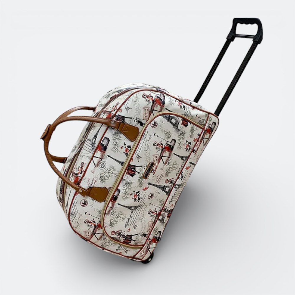 AïtaVia cream travel bag with a Parisian print, featuring Eiffel Tower motifs and red accents. Includes brown leather handles and a retractable black pull handle.