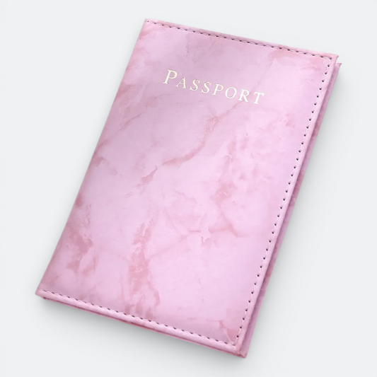 AïtaVia pink marble passport holder with "PASSPORT" embossed in gold.