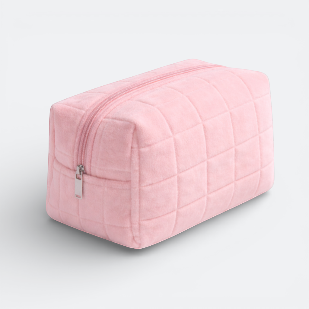 AïtaVia pink plush quilted makeup bag with a silver zipper. Soft and practical for travel.
